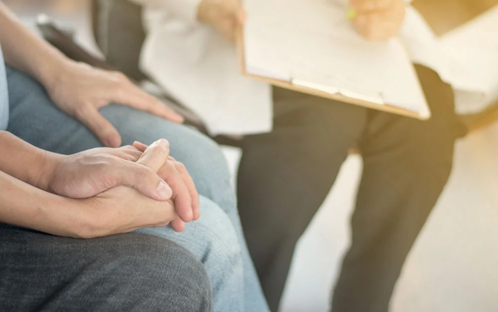 family sitting together in consultation during therapy session