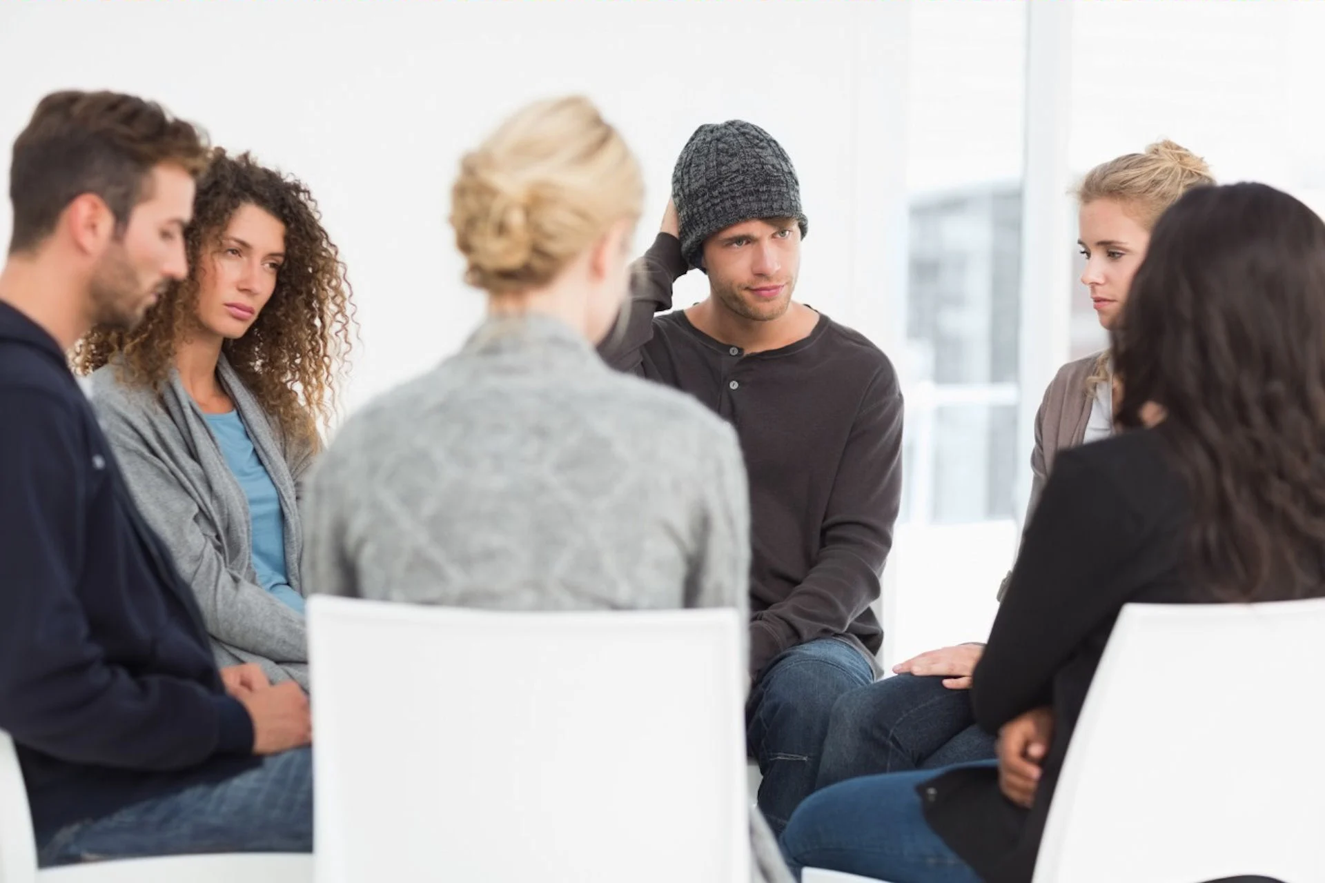 group of people with bpd in therapy session talking with therapist