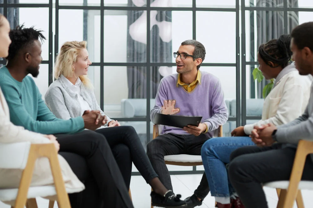 business training and coaching in the company. people sit and chat group of people sitting and discussing mental health stigma therapy