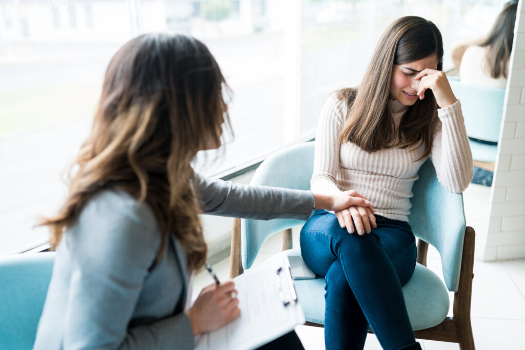 woman talking to therapist about financial anxiety