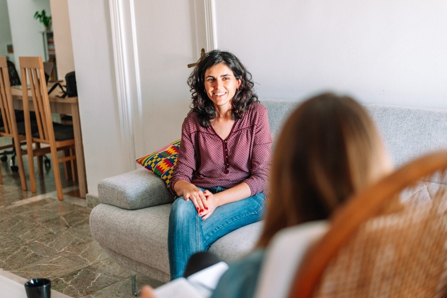 a woman sitting on a couch during therapy