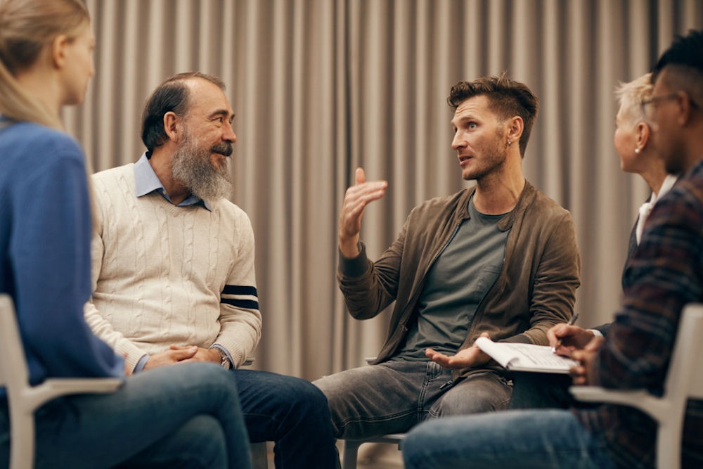 a group of people discussing during therapy
